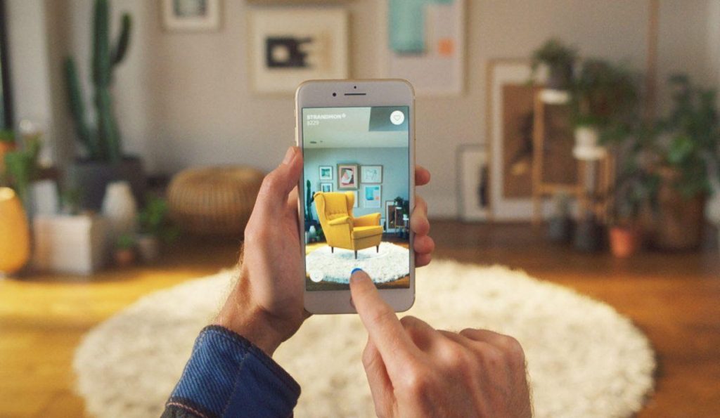 A person scanning an IKEA chair on an IKEA Place AR application.